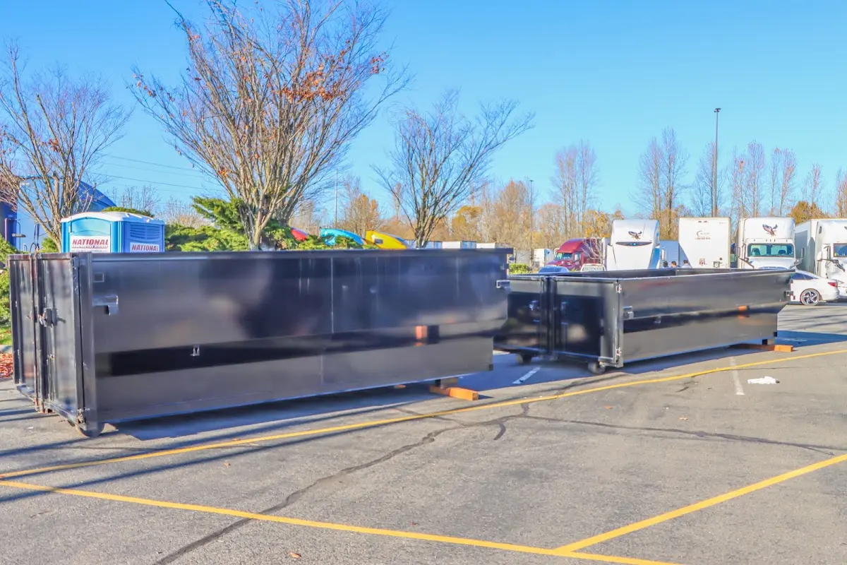 Professional dumpster rental service with roll-off container on residential driveway in Gladeview